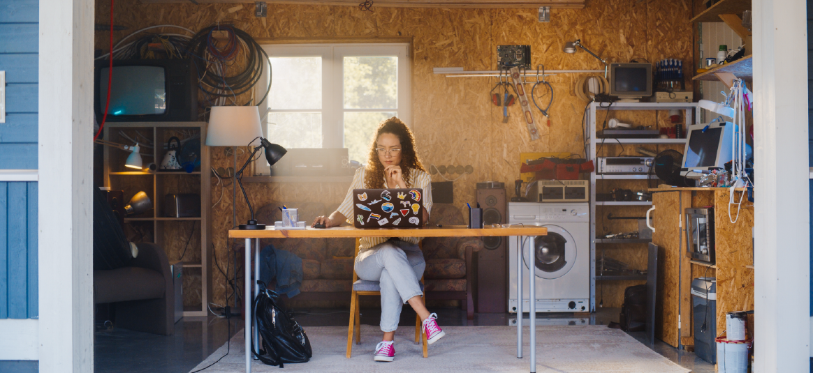 Photo of a woman sitting at a desk in a garage