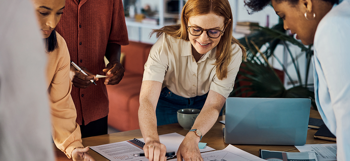 People planning on paper around a desk