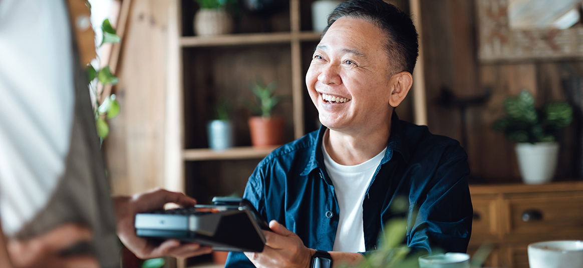 A customer making a contactless payment using their phone