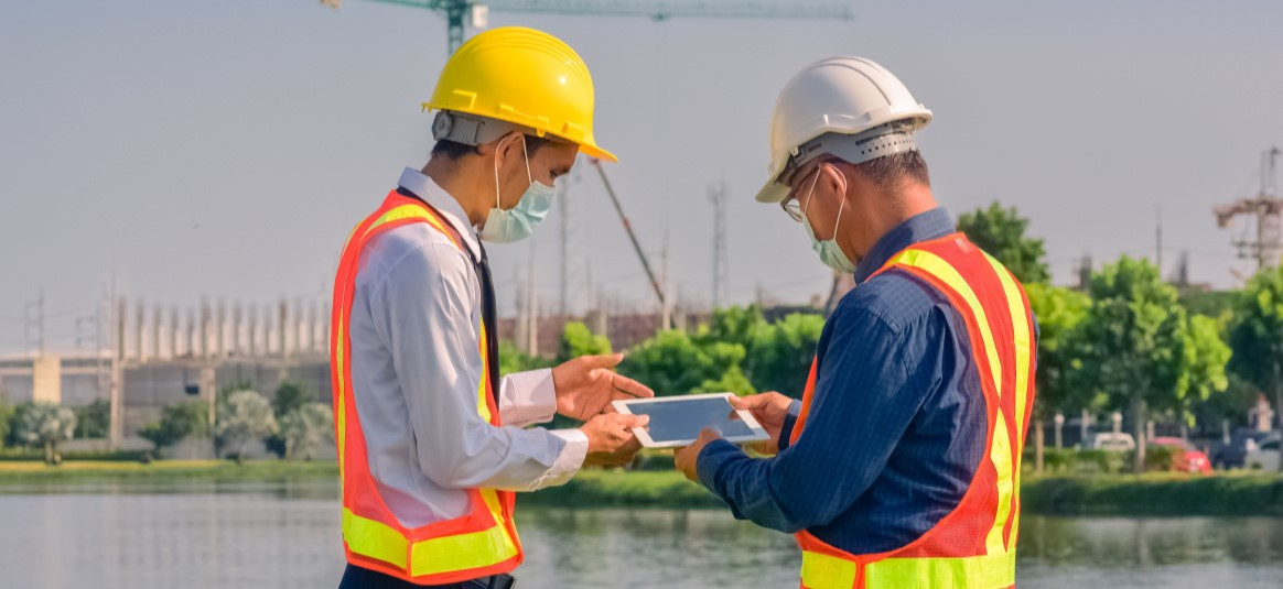 Photo of two people using a tablet on a worksite