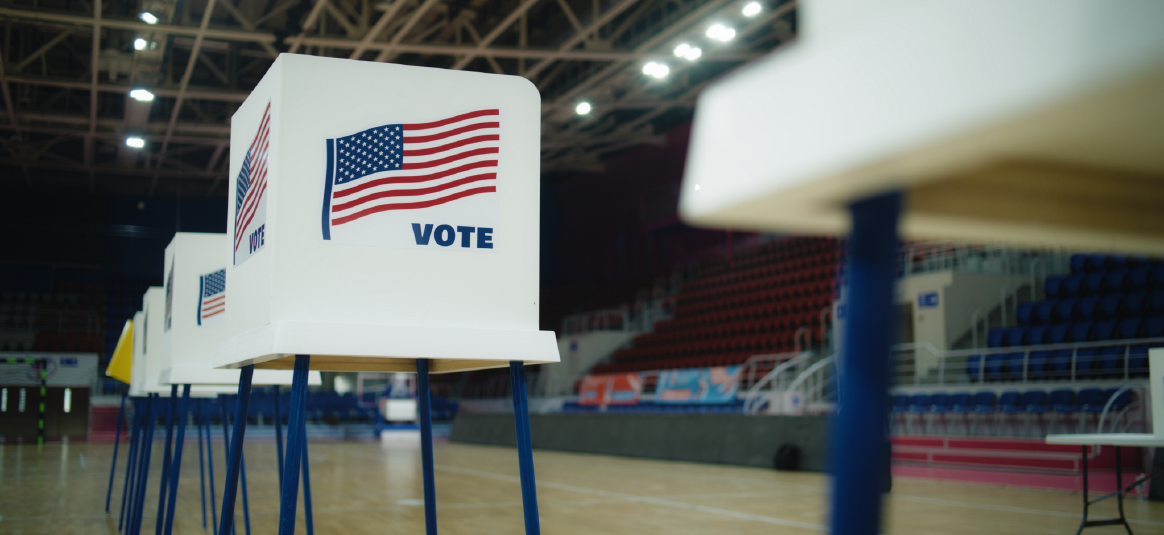 Ballot boxes with the stars and stripes, located in an empty sports hall