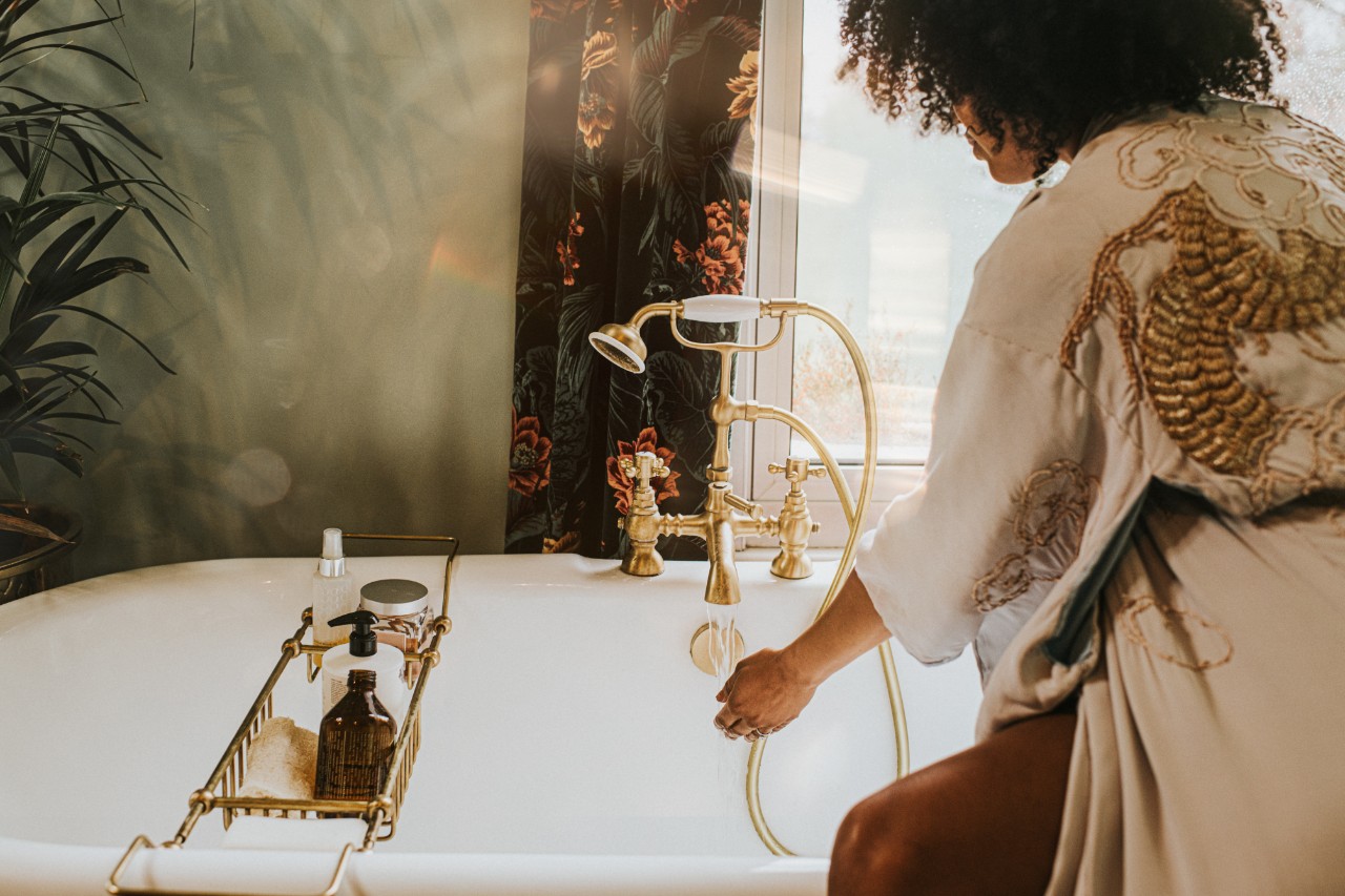 Woman running bath using NatWest Premier banking service