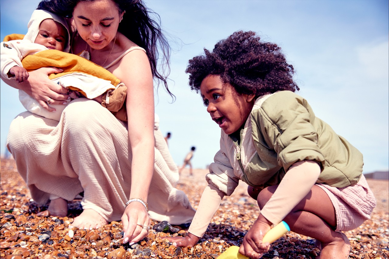 Mum and kids on the beach thiking about NatWest Premier financial planning