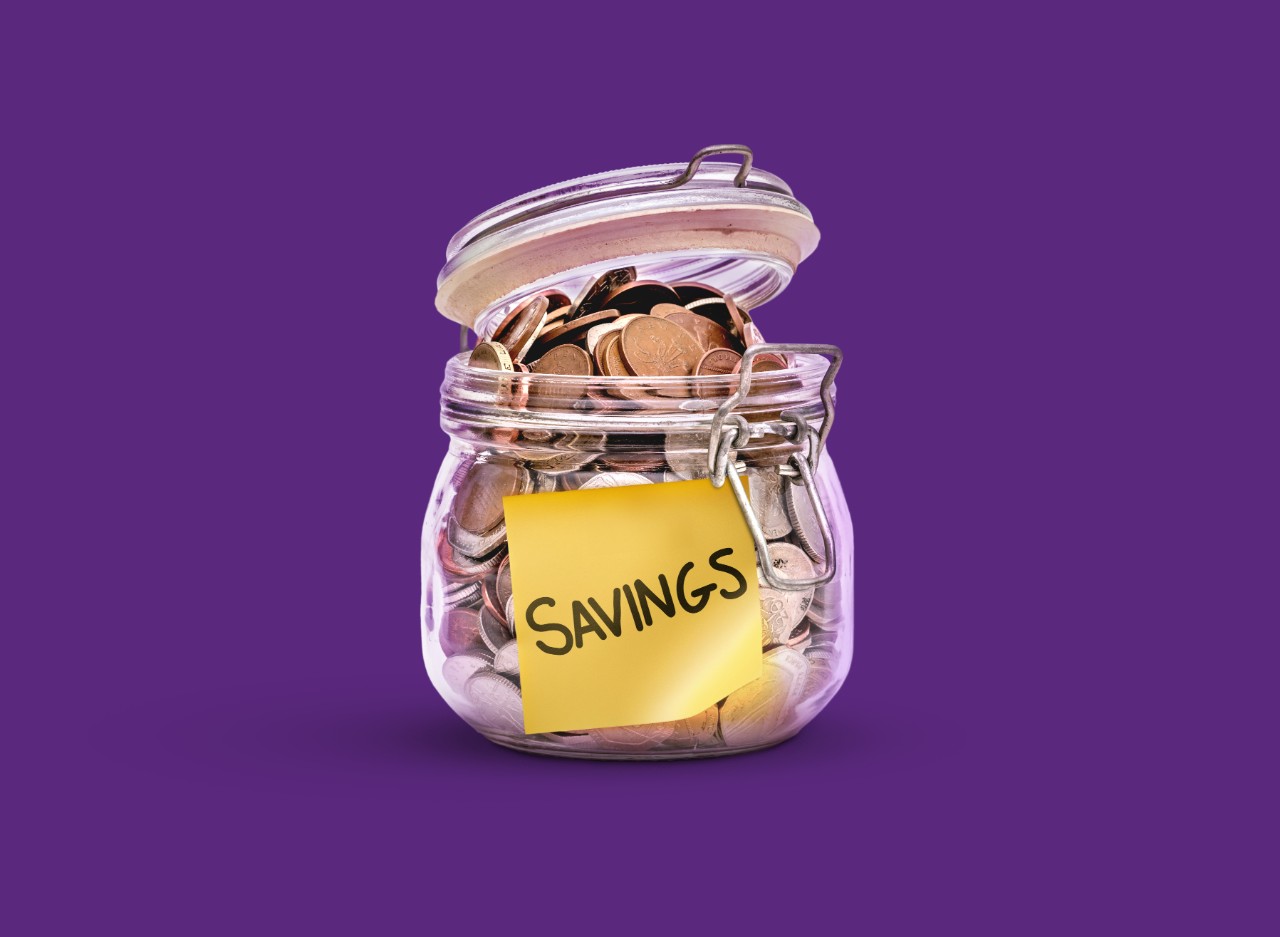 jar filled with coins and savings label